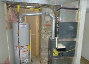 Water heater and furnace system installed in a basement with exposed pipes.