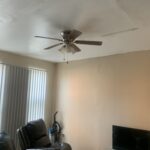 A living room with a small ceiling fan